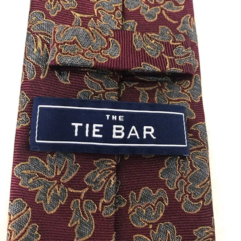The Tie Bar deep red with‎ blue and gold floral design necktie.